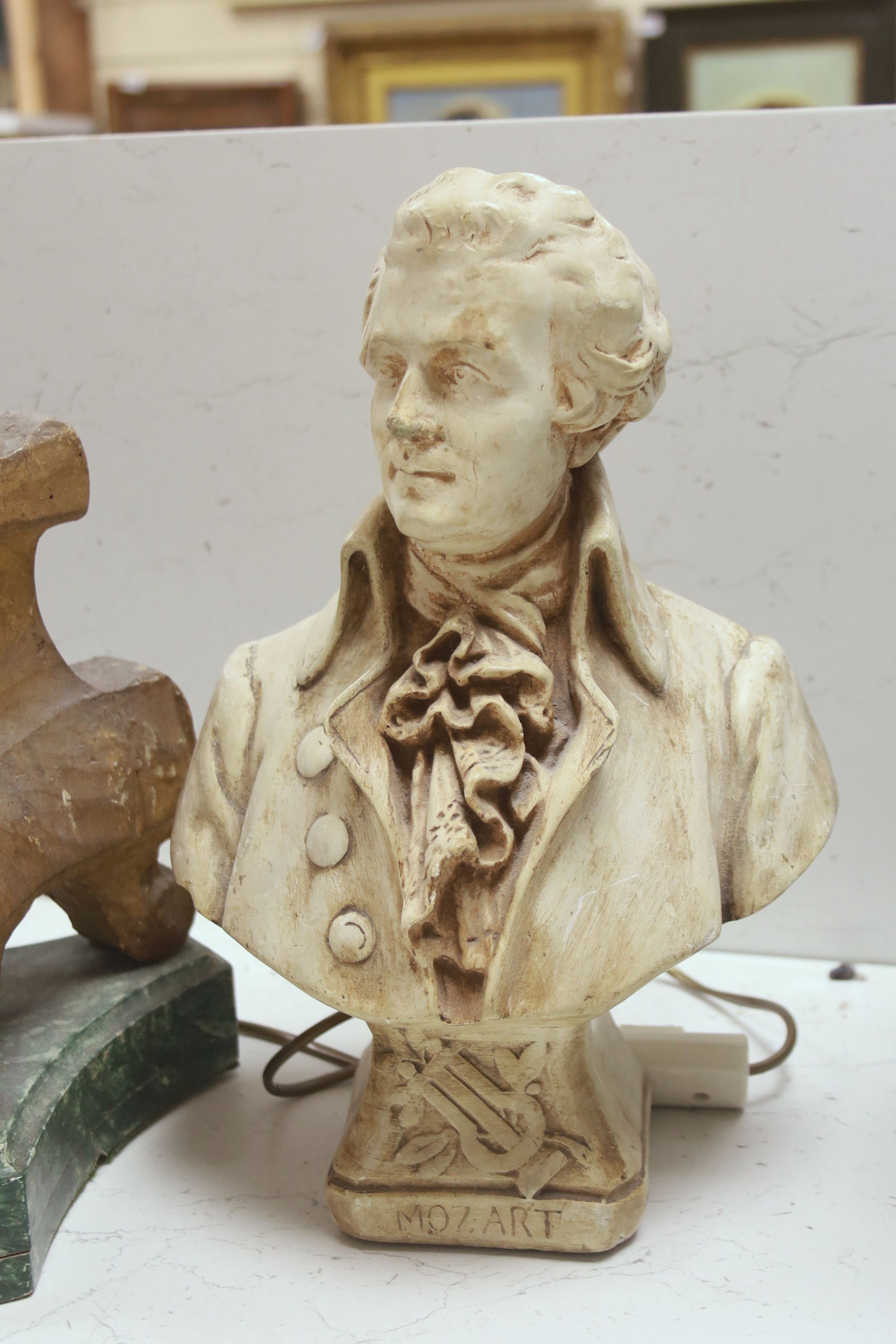 A giltwood altar candlestick as a lamp, height 71cm (excl. light fitting) and a plaster bust of Mozart